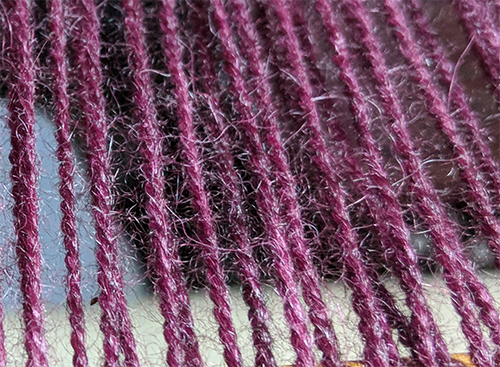 Burgandy alpaca yarns with a fuzzy halo