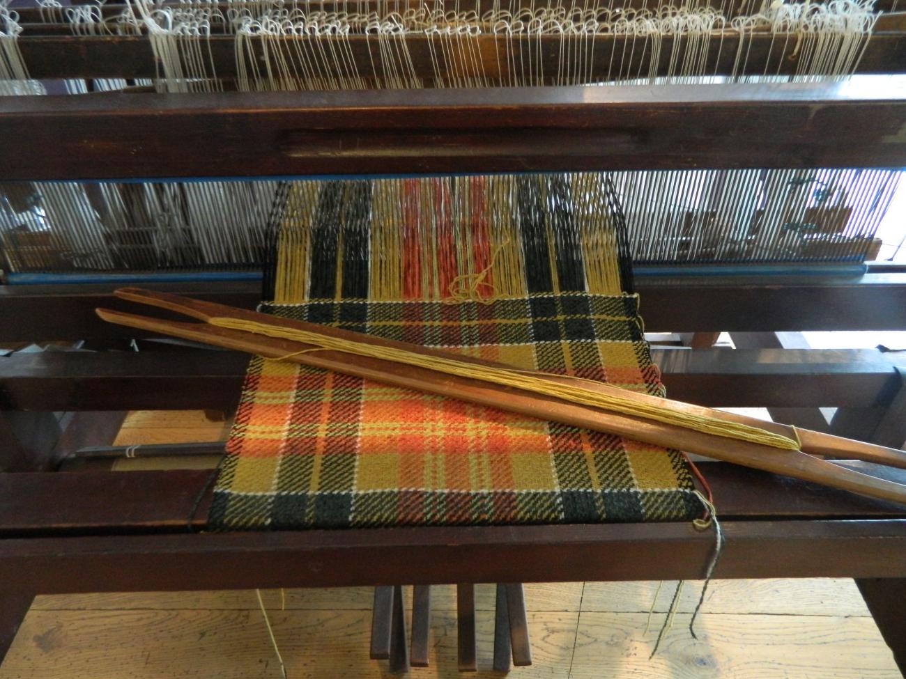 Cloth being woven on a loom